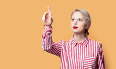 girl in a shirt with red stripes on yellow background