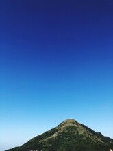 Low Angle View Of Mountain Against Clear Blue Sky