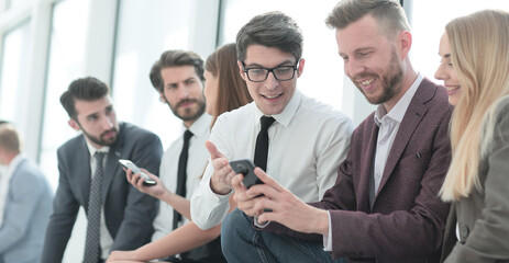 group of young employees discussing online news.