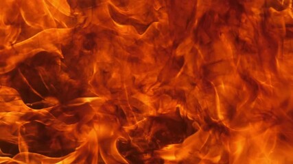 Wall Mural - slow motion speed close up scene of moving burning pattern as background. hot as inferno flame conce