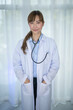 © MERCURY studio - Smiling female doctor in white coat with Medical stethoscope. Portrait beautiful young Asian Medical physician doctor.