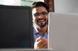 © IndiaPix - PORTRAIT OF A YOUNG EXECUTIVE HOLDING MUG AND SMILING AT CAMERA