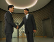 © SuperStock - Businessmen shaking hands in office lobby
