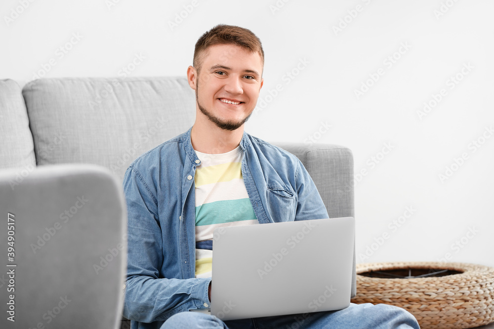 Young man using laptop at home