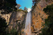 © SuperStock - Looking up steep rocky cliff face at water flowing down Purling Brook Falls on Gold Coast Hinterland