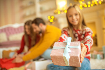 Wall Mural - Young family packing christmas gifts and looking involved