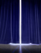 © SuperStock - White light glowing though gap in blue stage curtains.