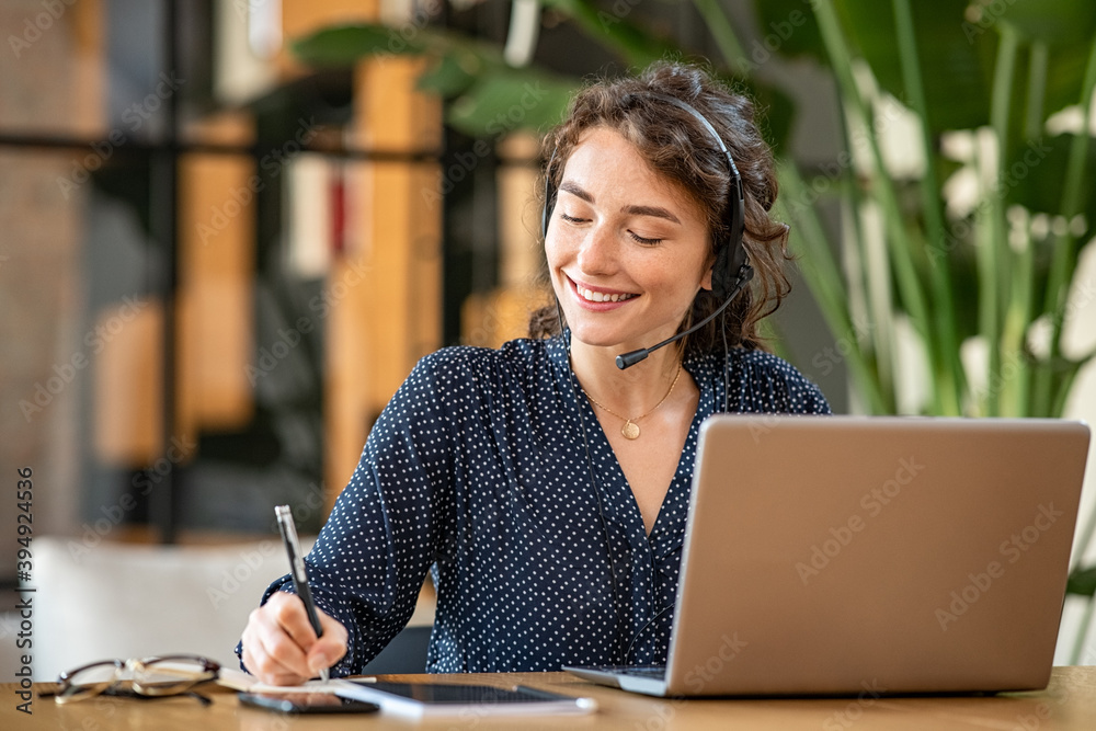 Successful customer service representative using laptop at office - obrazy, fototapety, plakaty 