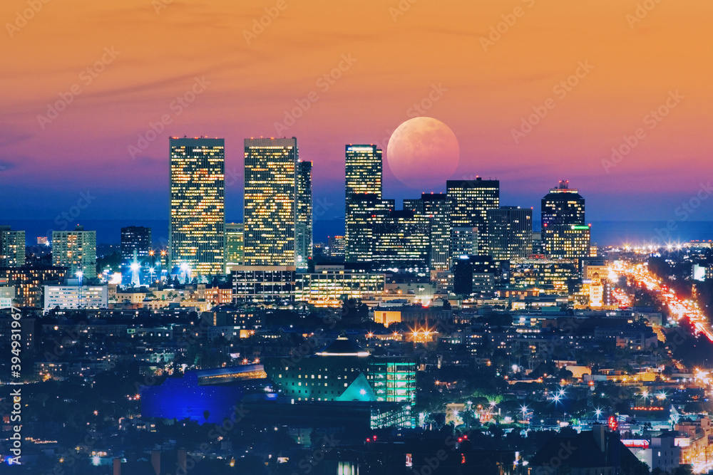 Ful moon rising over Los Angeles skyline at night Stock Photo | Adobe Stock