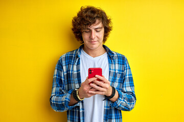 Wall Mural - serious teen chatting with girlfriend on mobile phone, communicating on smartphone, typing message