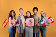 © Prostock-studio - Smillinge multi ethnic student in casual, hold small flags