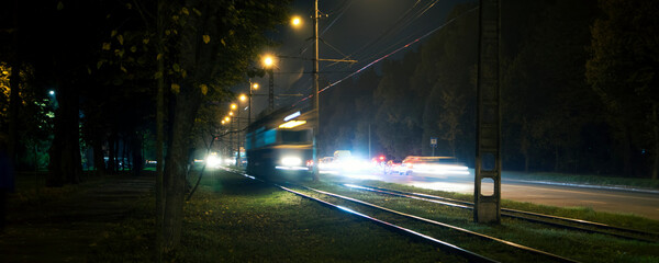 Wall Mural - The tram rides by railway  in the night city