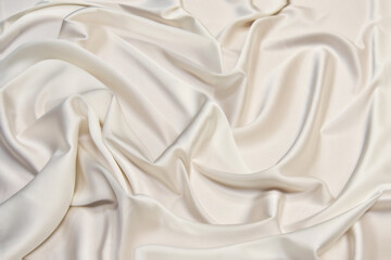 Smooth elegant champagne color silk or satin luxury cloth texture background.