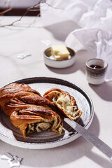 Wall Mural - Swirl brioche with poppy seeds served with butter and jam. Poppy seed braided or roll bread, Babka. Traditional sweet Christmas bread