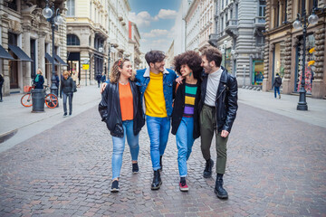 Group of friends schoolmate walking outdoors having fun hugging and enjoying time together