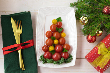 Christmas tree tomatoes on a plate. Christmas table setting