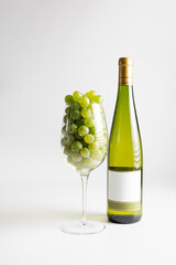 Wall Mural - Wine bottle and two wine glasses. Wine bottle against a white background