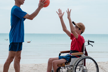 Wall Mural - Asian special child on wheelchair is smiling, playing, doing activity on  sea beach on summer, Lifestyle of disability child, Life in the education age, Happy disabled kid in travel holidays concept.