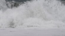 Stormy Sea Pushed By Heavy Rain And Wind Forms Big Waves That Break On The Beach