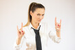 © Danko - Beautiful business woman over isolated background shouting with crazy expression doing rock symbol with hands up. Music star. Heavy concept.