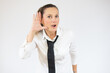 © Danko - Young business woman over isolated white background listening to something by putting hand on the ear