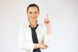 © Danko - Smiling business woman pointing up and looking at the camera over white background