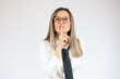 © Danko - Portrait of a confident young business woman showing silence gesture and looking at camera isolated over white background