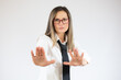 © Danko - Beautiful young business woman over isolated background Rejection expression crossing arms doing negative sign, angry face