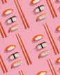 Pattern of sushis or niggiris with orange chopsticks over a pink background