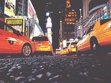 Low Angle View Of Yellow Taxi Amidst Illuminated Buildings At Times Square