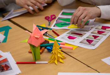 Students make a Tulip flower and a Christmas tree out of paper, origami, labor lessons.