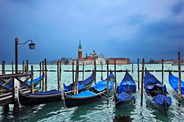  Gondolas in front of San Marco square, Venice, Italy. In the background, San Giorgio Maggiore.