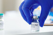 Hand of a doctor taking vial with sars-cov-2 vaccine