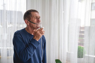 elderly senior with an oxygen mask in quarantine at home