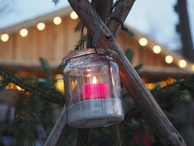 Close-up Of Candle Hanging On Wood