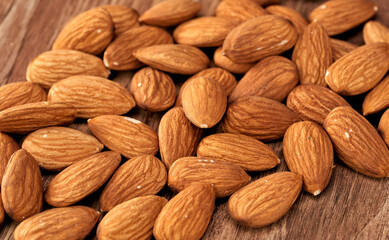 Wall Mural - Almond kernels lie on a dark background.Selective focus.Salted almonds.