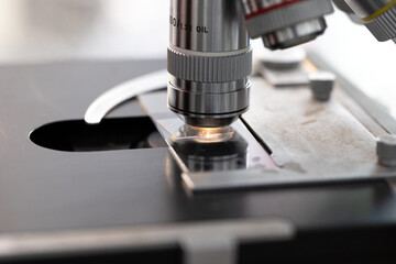 Wall Mural - Laboratory equipment optical microscope, closeup of scientific microscope with metal lens, data analysis in the laboratory