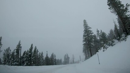 Canvas Print - Time lapse of car driving through mountains in winter, road trip in snowstorm