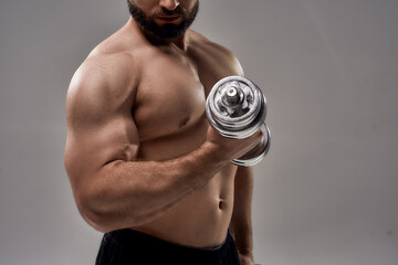 Poster - Figure of young muscular caucasian athlete lifting dumbbell