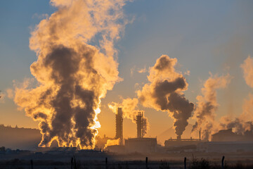 Factory smoke chimney piping smoke or steam into the air pollution