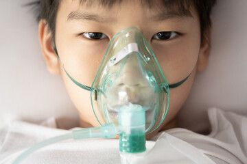 young asian boy with face oygen mask