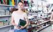 © JackF - Positive woman buying different products in stationery shop