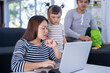 © KT Studio - Working mother work from home while babysitting her playful daughter at home. Working mother and Father playing with daughter beside.