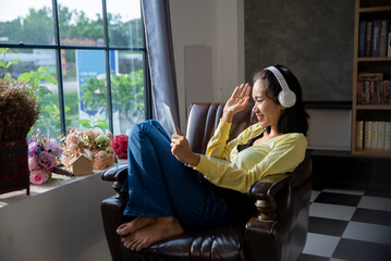 Wall Mural - Remote working and meeting at Home office Concept. Businesswoman working online via laptop. Asian young entrepreneurs watching webinars and talking during meeting video conferences calls with team.