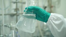 Scientist Hand Shaking Erlenmeyer Flask In Laboratory 4k