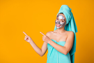 Wall Mural - Photo of young cheerful smile girl show point fingers empty space promotion ad spa treatment isolated over yellow color background