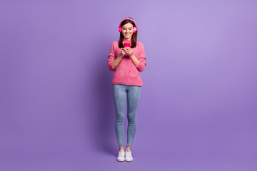 Poster - Full length body size photo of female blogger earphones with smartphone typing message isolated on vibrant purple color background