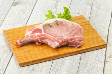 Raw pork bone steak over wooden