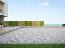 Beach House With Empty Cobblestone Floor For Car Park. 3d Rendering Of Green Grass Lawn In Modern Sea View Home.