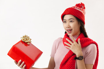 Portrait beautiful young Asian woman holding red gift box for Christmas concept on a white background
